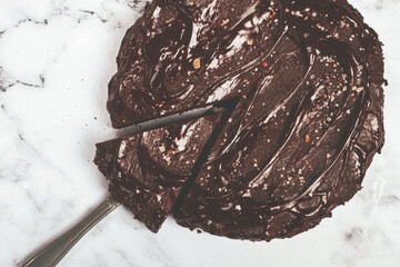chocolate cake, round cake, on a marble light table, top view, homemade cakes, no people,