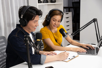 Smiling radio influencer hosts wearing headphones with channel social media online live streaming...