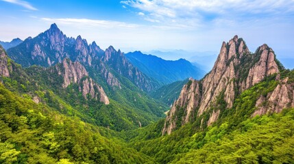 Fototapeta premium A breathtaking panoramic view of majestic mountain peaks enveloped in lush greenery under a clear blue sky, perfect for travel brochures, nature-themed websites, and adventure promotional materials,