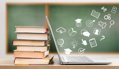 icons flying out of laptop, next to stack of books, on chalkboard background. e-learning concept