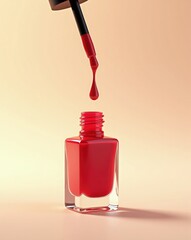 Red nail polish bottle with dropper applying a drop