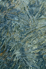 needles and crystals of melting transparent ice on the pebble shore of the northern Kolyma