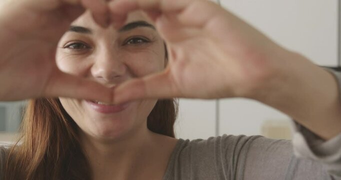 Woman making heart shape with hands
