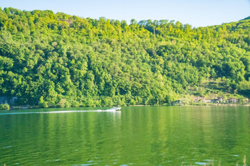 Spring view of Lake Lugano in the town of Caslano in the Swiss mountains