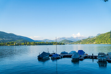 View of boats moored on Lake Lugano, village of Caslano. Switzerland