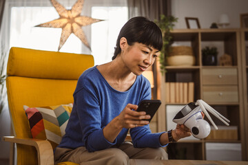 mature japanese woman adjust prepare home surveillance security camera