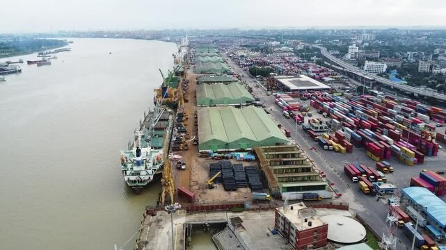 Drone footge of Chittagong of chattogram port yard and container handling from ship. Container yard, key grantee crane,mother vessels and loading unloading photographs. - Powered by Adobe