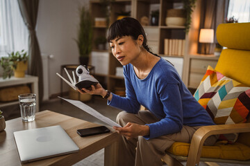 mature japanese woman adjust prepare home surveillance security camera