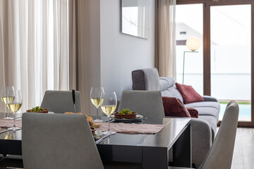 Dining table setup with wine and soft seating