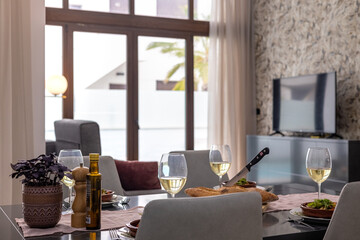 Elegant dining table with wine, salad and bread