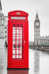 Obraz premium Iconic red telephone booth standing in Westminster with Big Ben in London, UK