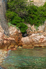 Rocks, stones and sea, close-up, top view. Coast of the Adriatic Sea, Montenegro. Vertical