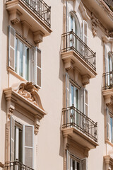 Classic Facade With Iron Balconies and Open Shutters