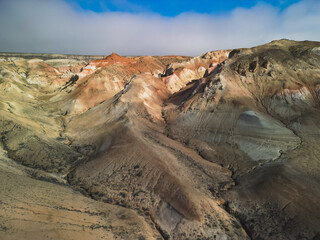 Golden light moves along winding ravines and sculpted Aktumsuk formations. The camera flows over...