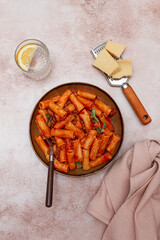 Rigatoni pasta with meat sauce and parmesan cheese on a light table, top view, homemade, no people,