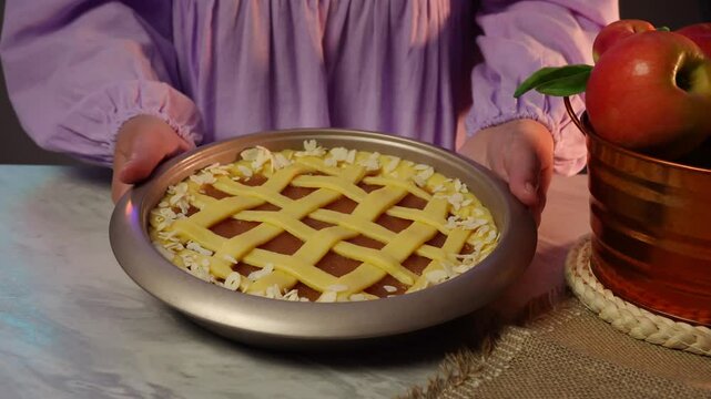 Hands gently preparing latticetopped apple pie in rustic setting