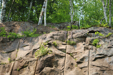 a rock face that has been prepared for climbing. lines on surface from past quarry use. beautiful...
