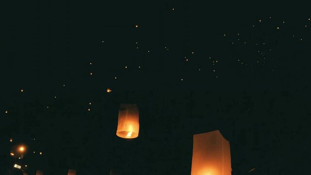 Illuminated Sky Lanterns Ascending at Night