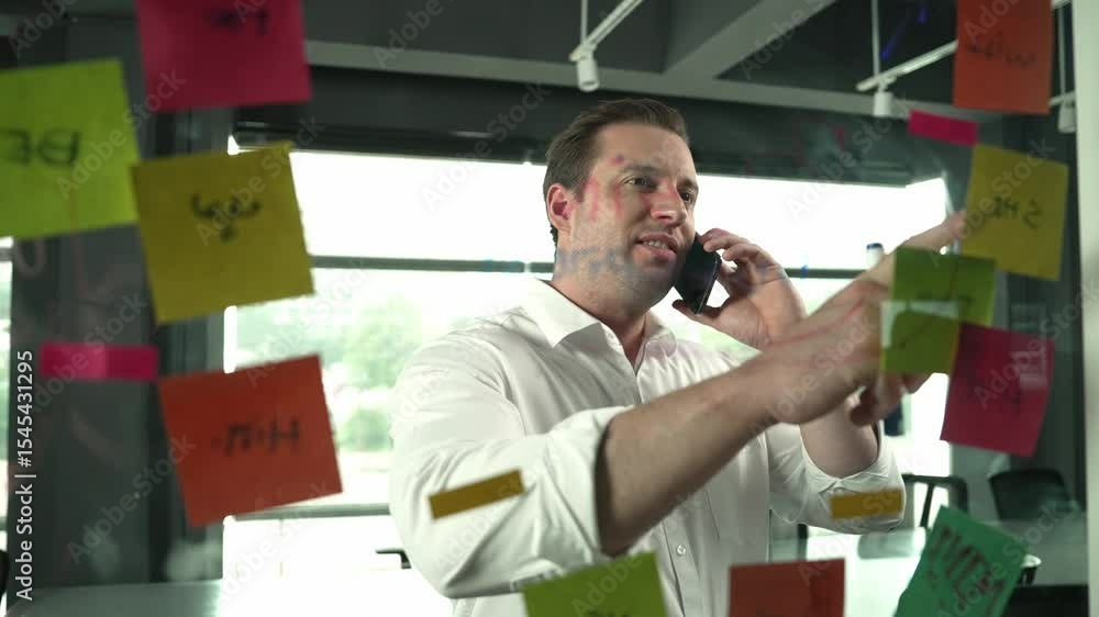 Poster professional businessman making phone call to customers while looking at marketing strategy idea wri