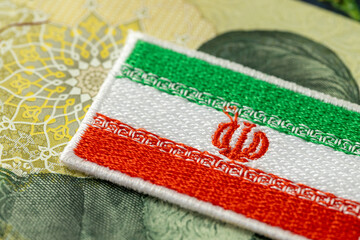 The symbol of Iran covering the image of the Ayatollah.