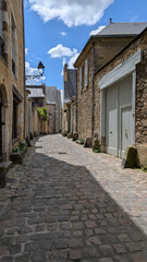 Modern life in a medieval town with stone masonry, cobblestone alley