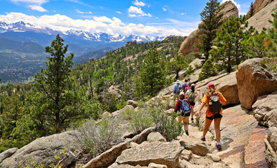 Hikers descending the Gem Lake Trail in Rocky Mountain National Park, Colorado