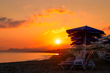 Morning on the beach near the sea. Crete, Retimno. Beautifull sunrise on the beach line.