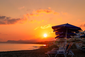 Morning on the beach near the sea. Crete, Retimno. Beautifull sunrise on the beach line.