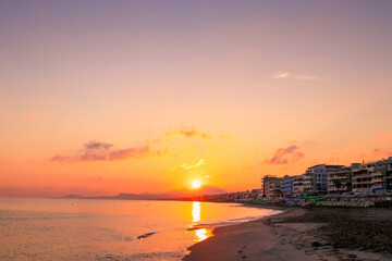 Morning on the beach near the sea. Crete, Retimno. Beautifull sunrise on the beach line.