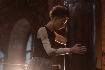 Short-haired fighter in boxing ring, cinematic rest moment between intense rounds.