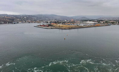 Ensenada, Mexico, June 5, 2025: The Entrance to Ensenada Harbor looking at the industrial quay for repairs and shipping.