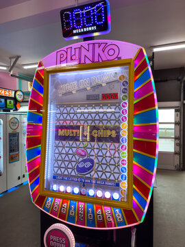 Plinko Arcade Game Machine with Bright Lights

