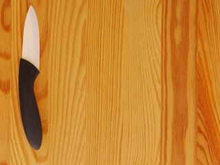 A knife is on a wooden table