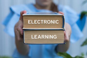 Young girl holding two books with inscription on side: ELECTRONIC LEARNING. E-learning Electronic Learning Concept. Elearning online technology.