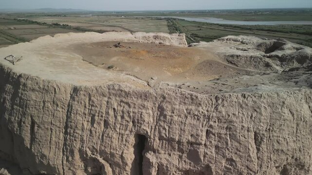 The Chilpik tower stands tall with visible erosion on its rim. Built for sky burials, the site is near the Amu Darya river. Sacred ground from the ancient Khorezm era.