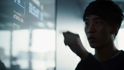 Focused cyber security expert strategizing attack defense using digital display - Powered by Adobe