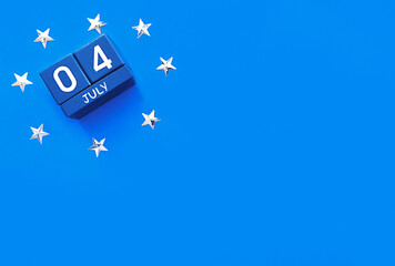 A blue block of a calendar is set for July 4th and surrounded by white stars on a blue background...