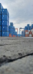 A road flanked by stacks of containers