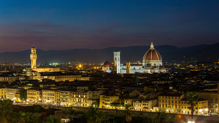 Fototapeta premium Stunning night panorama of Florence, Italy, with the illuminated Duomo and city lights from Piazzale Michelangelo. Beautiful European travel destination
