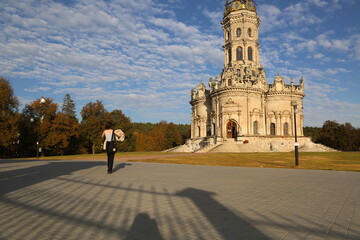 Teen girl with shot hair standing in front of Cathedral christ the savior. Old christianity churth...