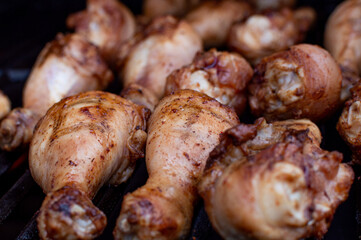Smoky Chicken Legs Cooking on Outdoor Grill in Summer. Flat-Lay of Seasoned Chicken Drumsticks on BBQ Grill