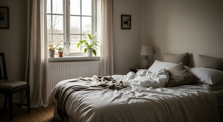 Fototapeta premium Interior of bedroom with unmade bed and window with plants and curtains in natural light setting