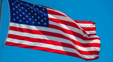 American flag waving beautifully against a clear blue sky