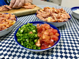 Food Prep on Checkered Tablecloth with Chicken and Vegetables