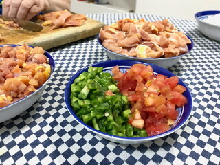 Food Prep on Checkered Tablecloth with Chicken and Vegetables