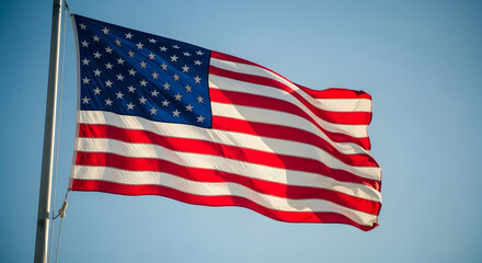 Obraz premium American flag waving proudly in a clear blue sky