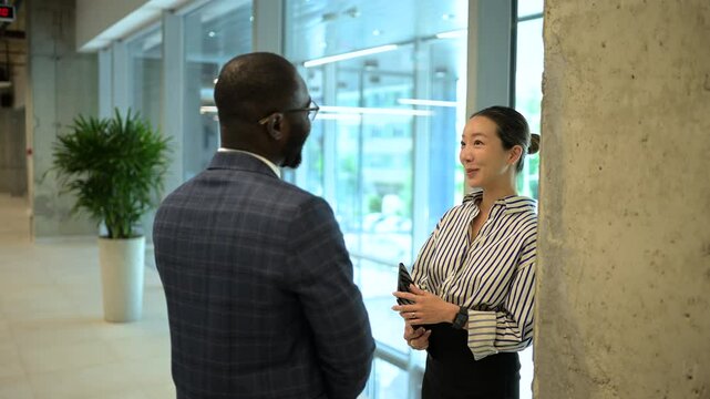 Business colleagues engaging in conversation in modern office
