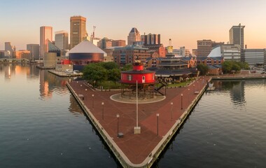 Baltimore Inner Harbor, USA, at dawn. The Seven Foot Knoll Lighthouse stands on a pier, with the...