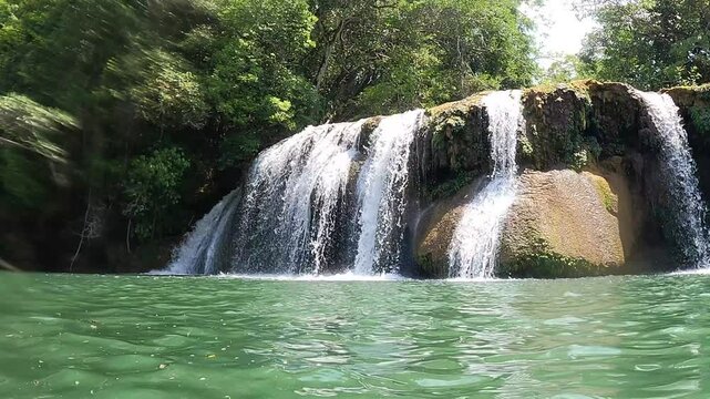 Beautiful waterfall in a rainforest on a sunny day. Ecotourism trip in Mato Grosso do Sul, Brazil