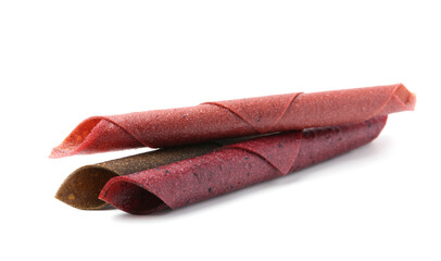Delicious fruit leather rolls on white background